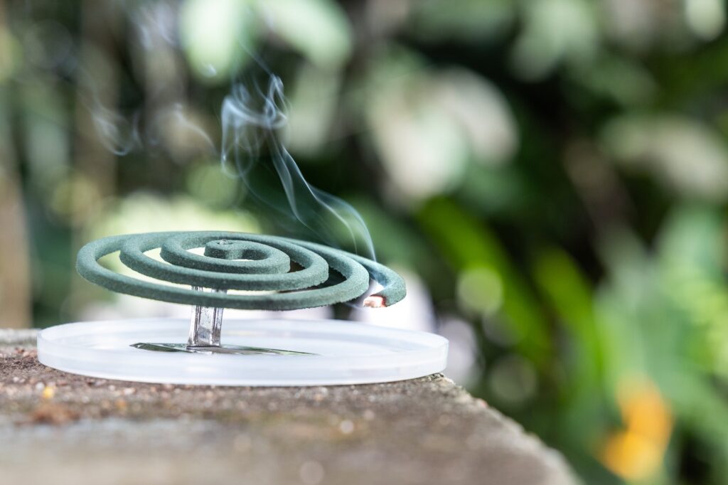 Closeup on traditional mosquito repellent coil emit smoke to repel mosquito outdoor